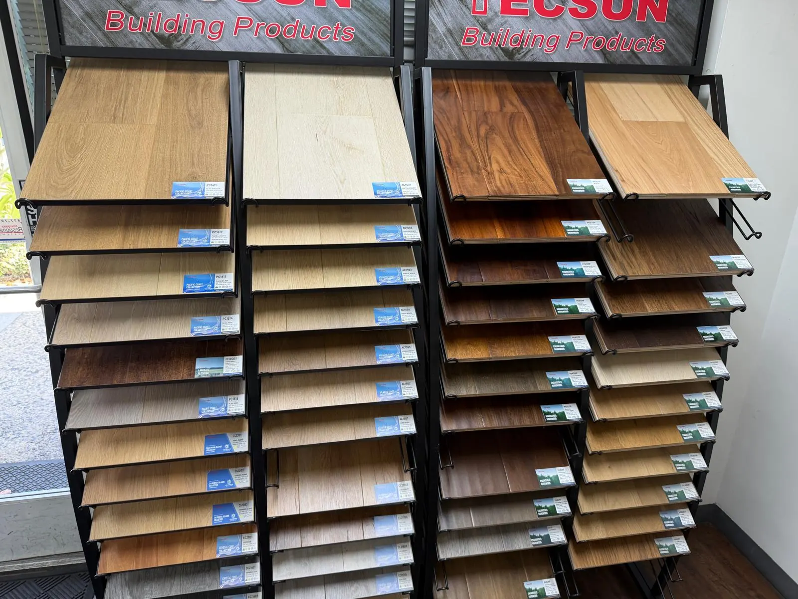 Flooring sample boards hanging on display racks in the Velmont mobile flooring showroom