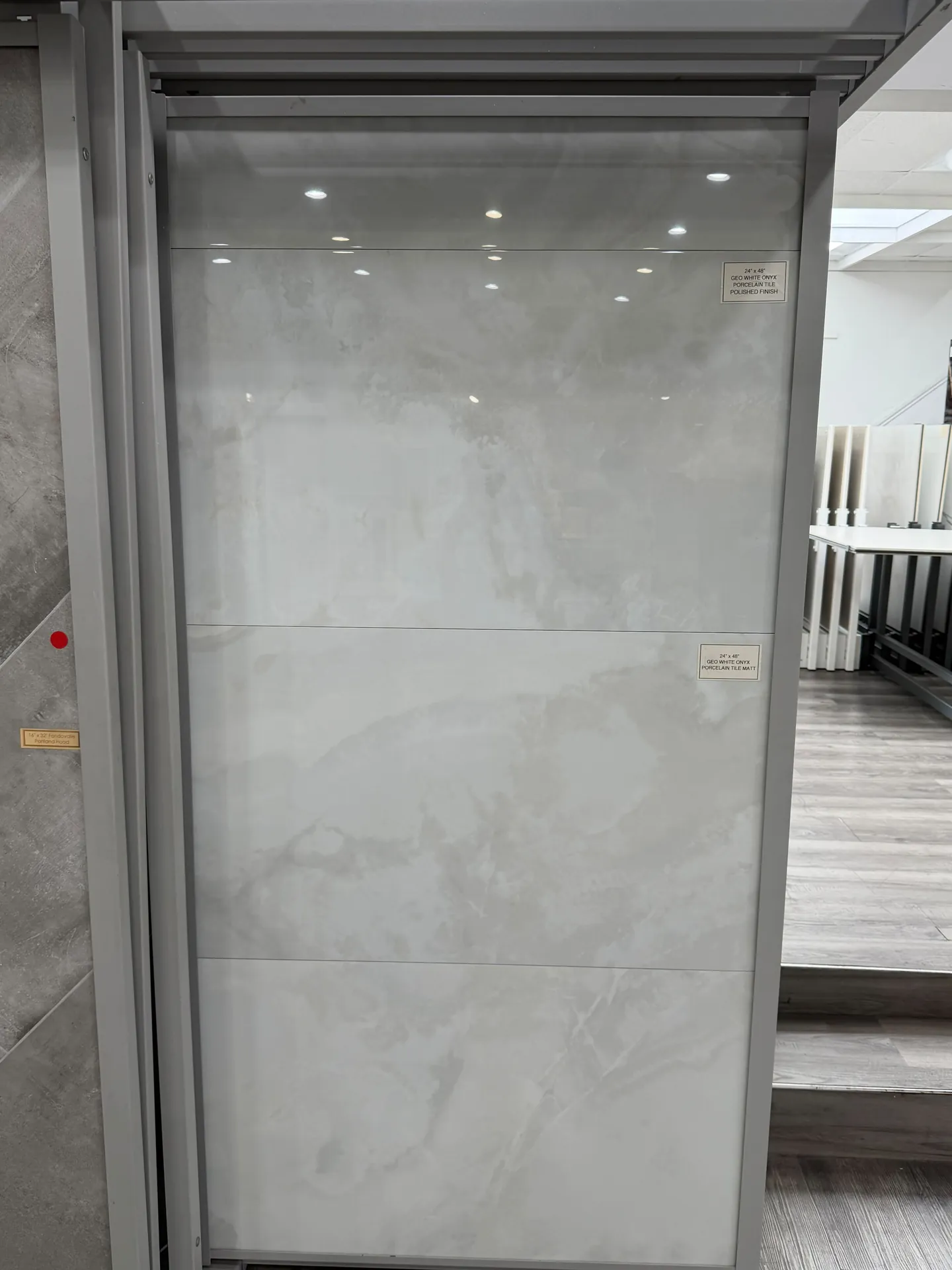 Large format marble look porcelain slab on a display rack in the mobile flooring showroom